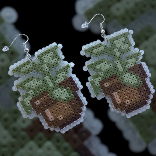 Handmade fuse bead earrings with leafy plant pot design and silver hook findings on kraft card backing