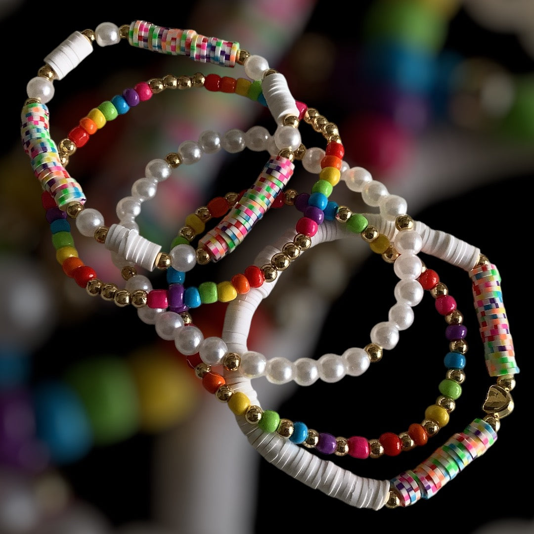 Rainbow Confetti bracelet stack – multicolour seed beads and pearl-look accents

Handmade 5-piece bracelet set with silver and bright colours

Playful bracelet stack with rainbow tones and party vibe – Rainbow Confetti

Colourful beaded stretch bracelets with pearls and clay discs

Bright 5-piece handmade bracelet set – perfect for gifting