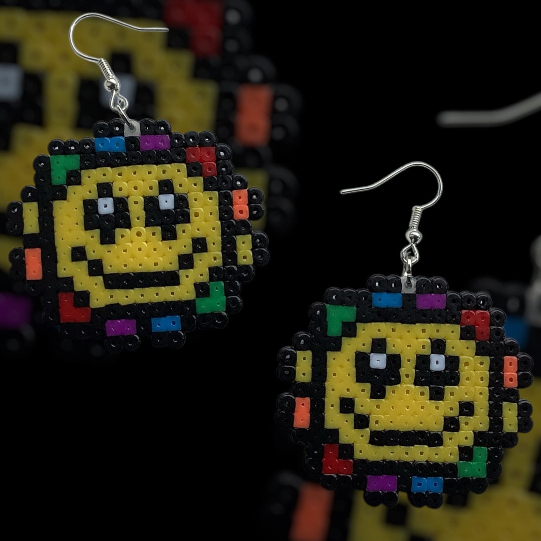 Handmade fuse bead earrings featuring smiling flower design with nickel-free hook findings on kraft card backing